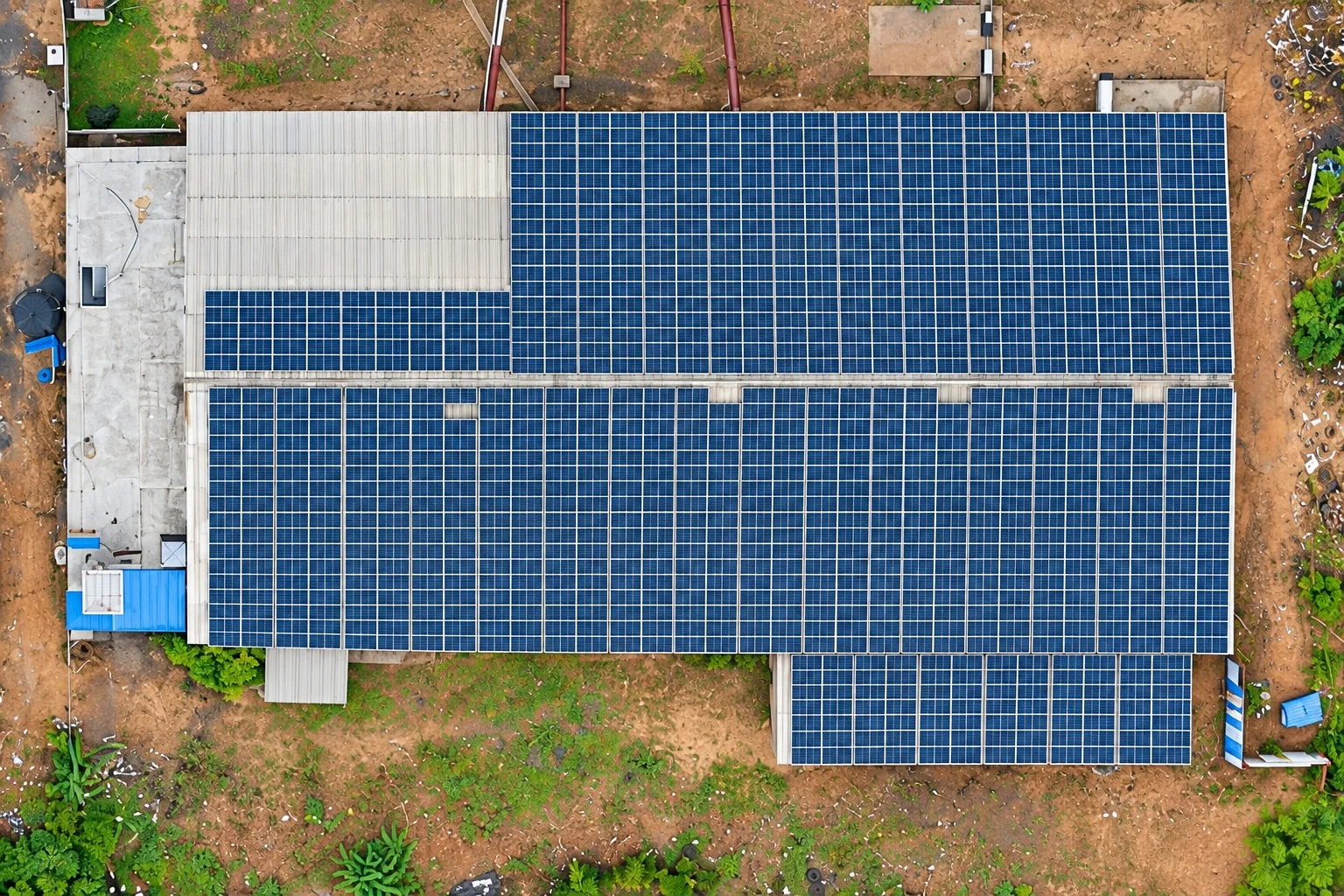 Close aerial view of the existing rooftop solar panel installation at the Venkadeshwara manufacturing facility